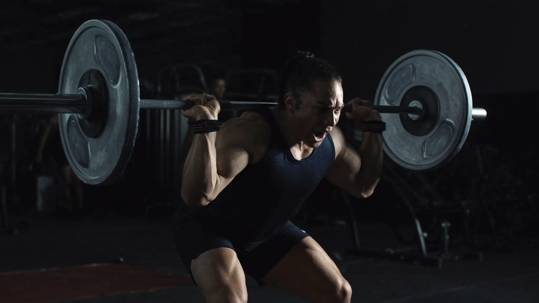 Personal trainer coaching a client in a premium gym