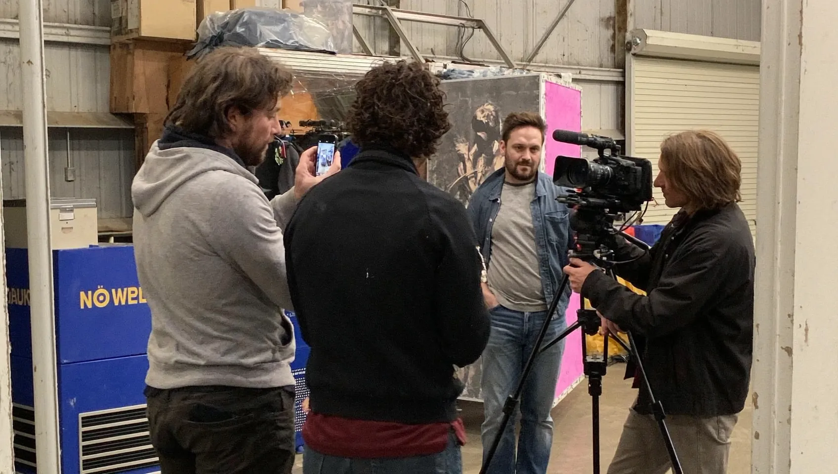 Team filming a behind the scenes clip on a phone for social media content