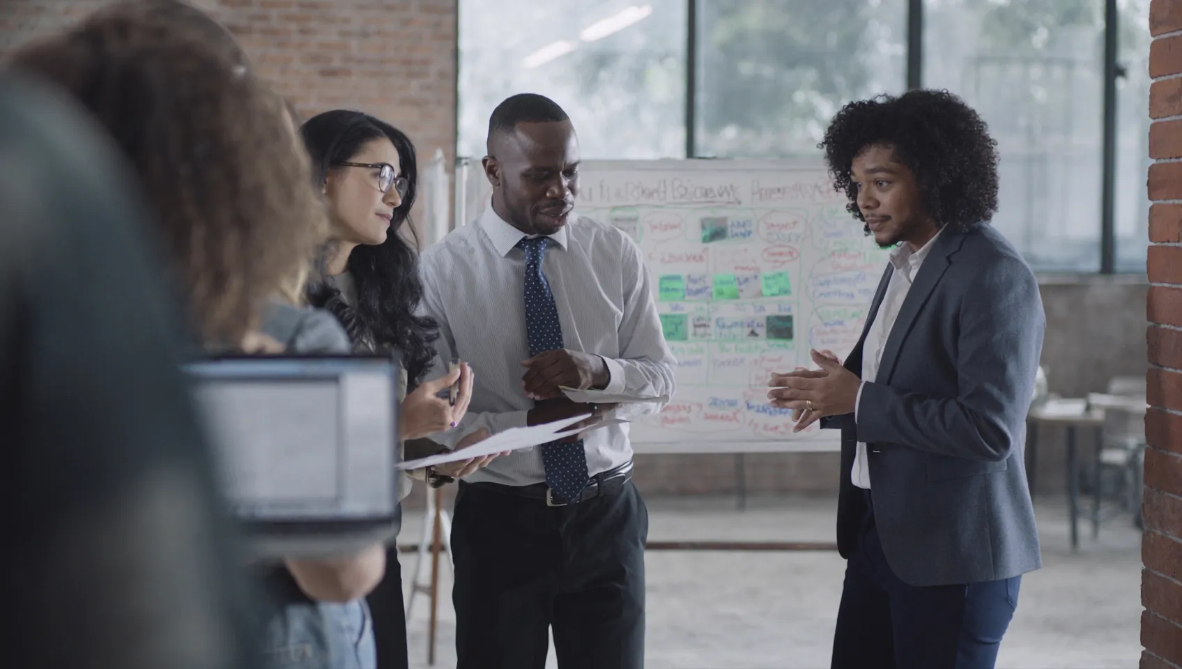 Small business team reviewing customer reviews and brand feedback together